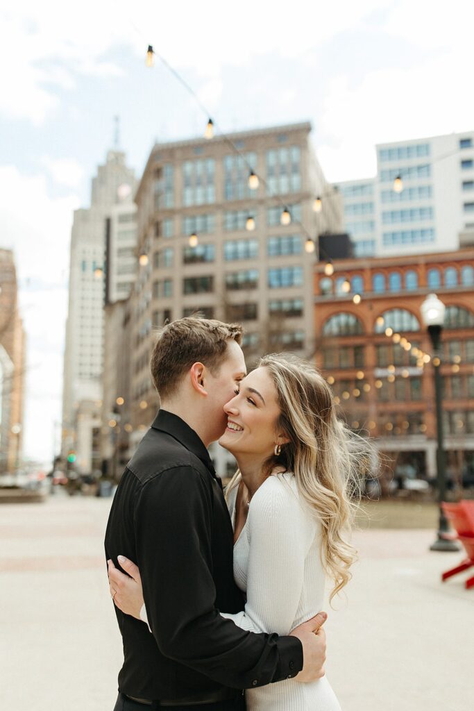 Couple posing downtown for their Detroit engagement photos