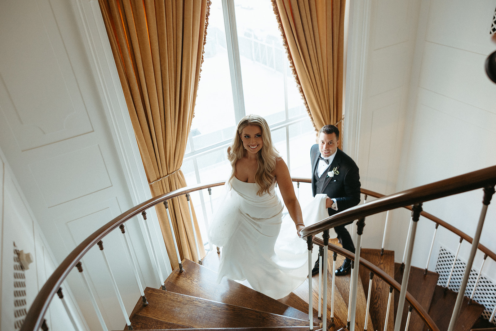 Bride and groom walking up the staircase at Colony Club - Detroit Area Wedding Venues