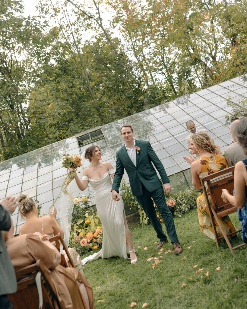 Bride and groom walking back down the aisle as husband and wife after their Glass House Creative Community wedding ceremony