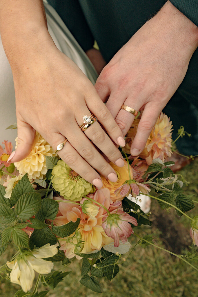 Bride and groom showing off their wedding detail shot