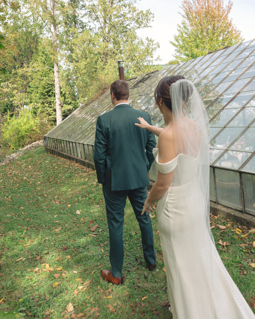 Bride tapping the groom on the shoulder to share their first looks