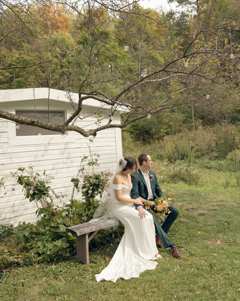 Bride and groom sitting together on the venues property