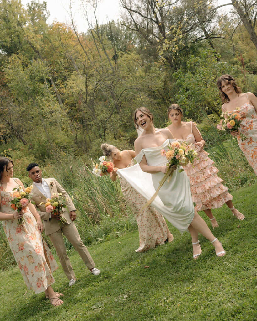 Outdoor documentary style bride and bridesmaids portraits at Glass House Creative Community in Zeeland, MI