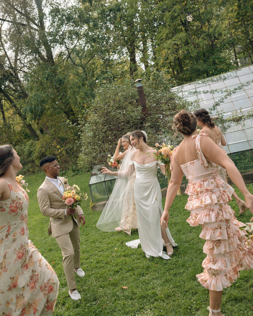 Outdoor documentary style bride and bridesmaids portraits at Glass House Creative Community in Zeeland, MI