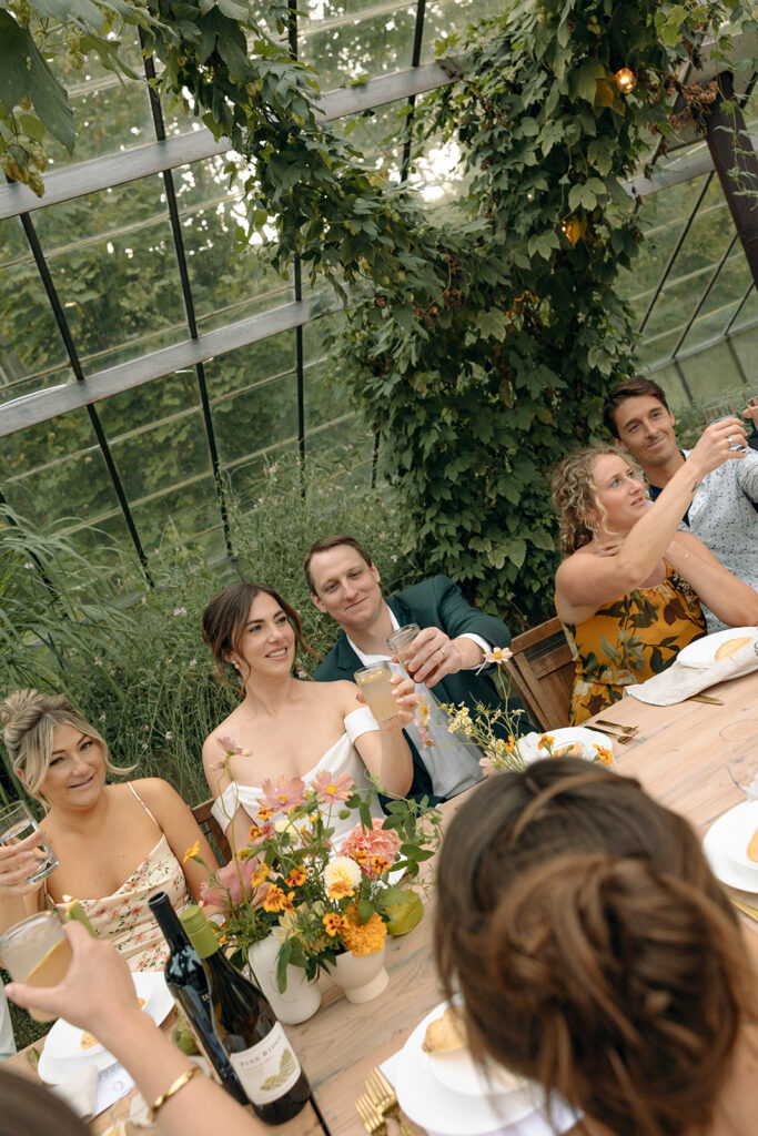 An indoor Glass House Creative Community wedding reception in the greenhouse 