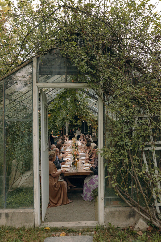 An indoor Glass House Creative Community wedding reception in the greenhouse 