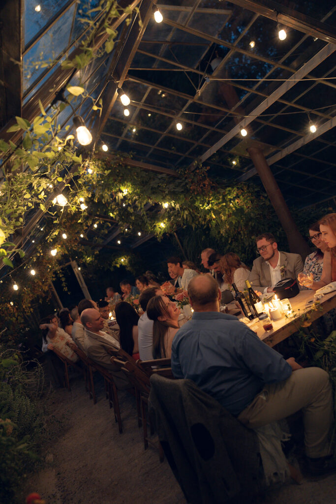 An indoor Glass House Creative Community wedding reception in the greenhouse 