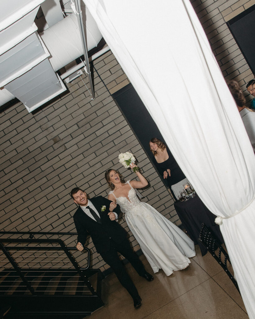 Bride and groom entering their indoor Port 393 wedding reception