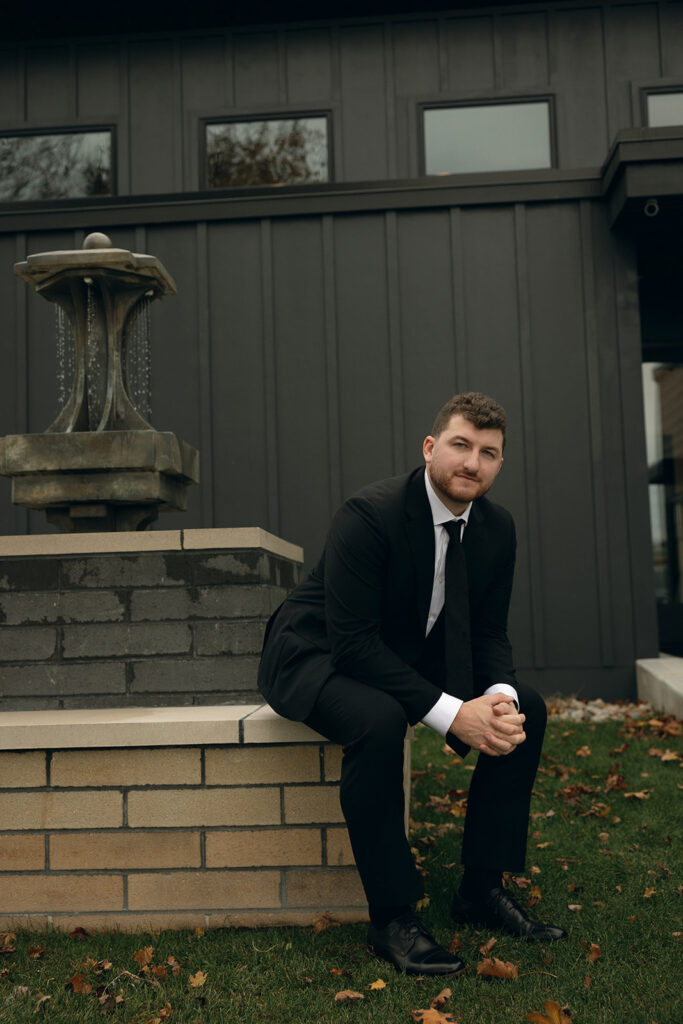 Outdoor grooms portraits outside of The Cove House from a Port 393 wedding in Holland, MI