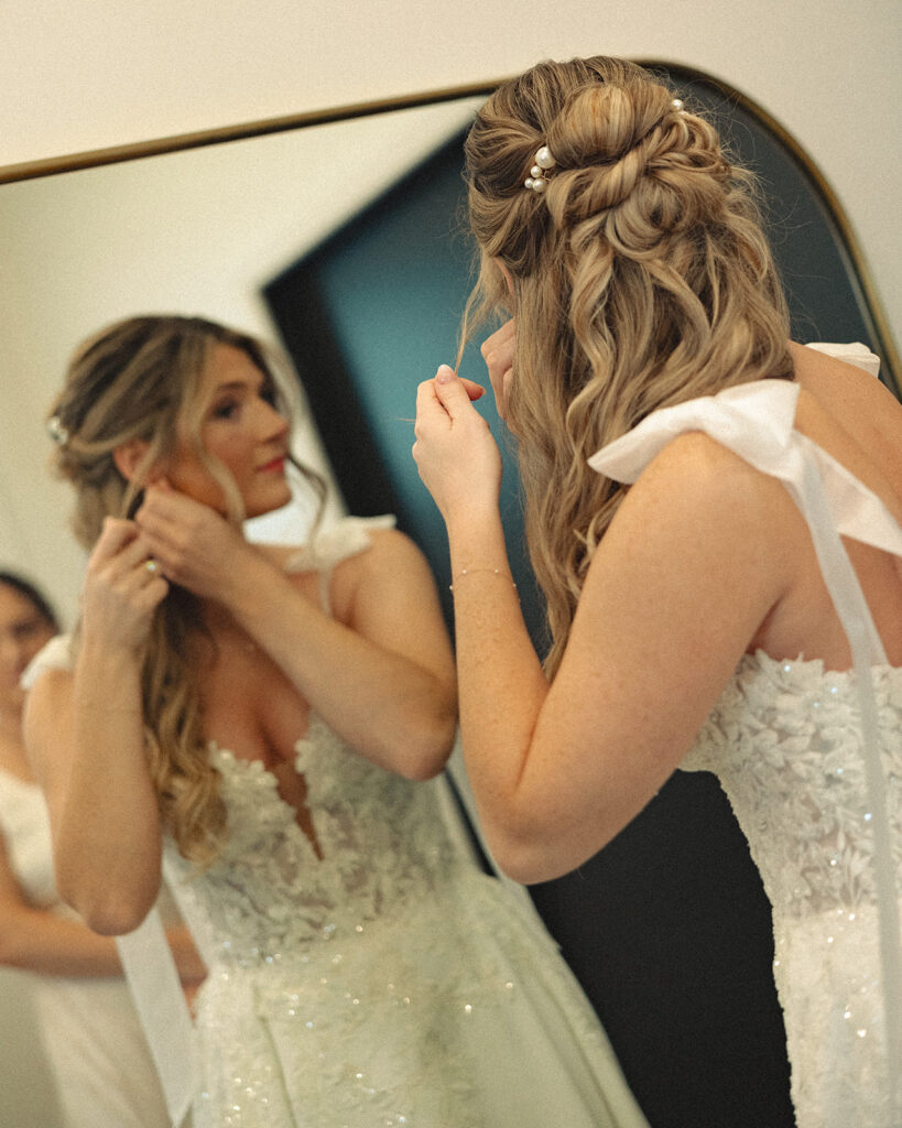 Bride putting her earrings in