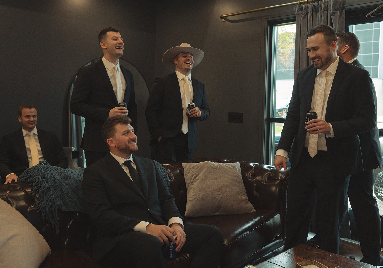 Groom and groomsmen hanging out at The Cove House before the Port 393 wedding in Holland, MI