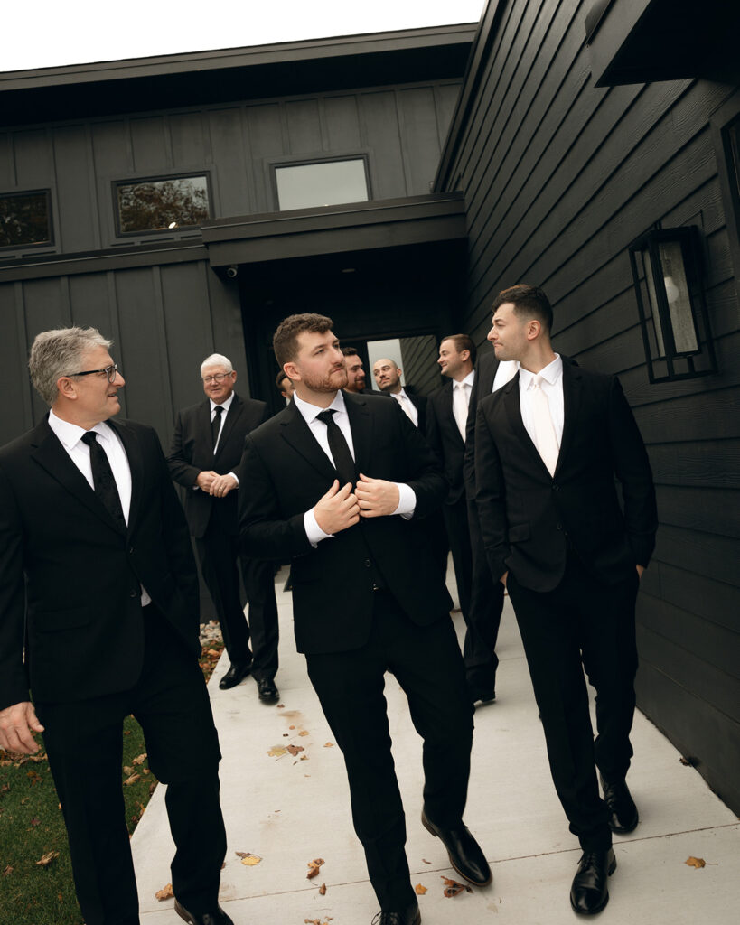 Groom and groomsmen portraits outside of The Cove House from a Port 393 wedding in Holland, MI