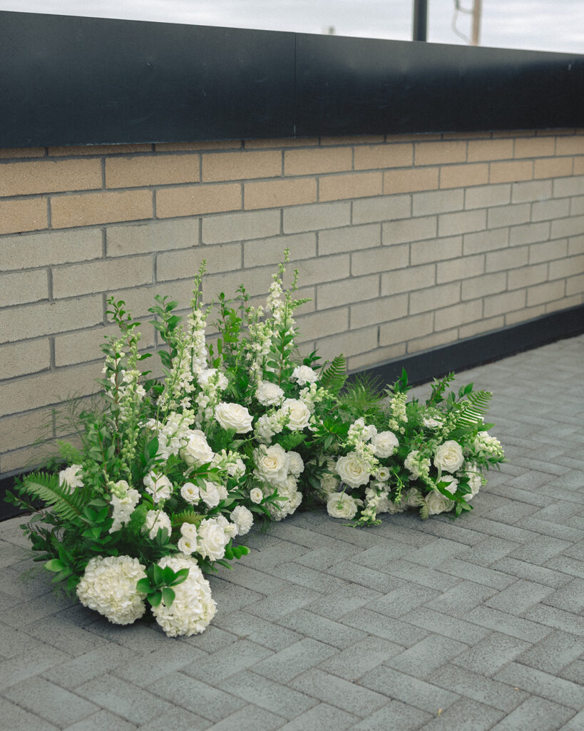 Rooftop patio wedding ceremony florals