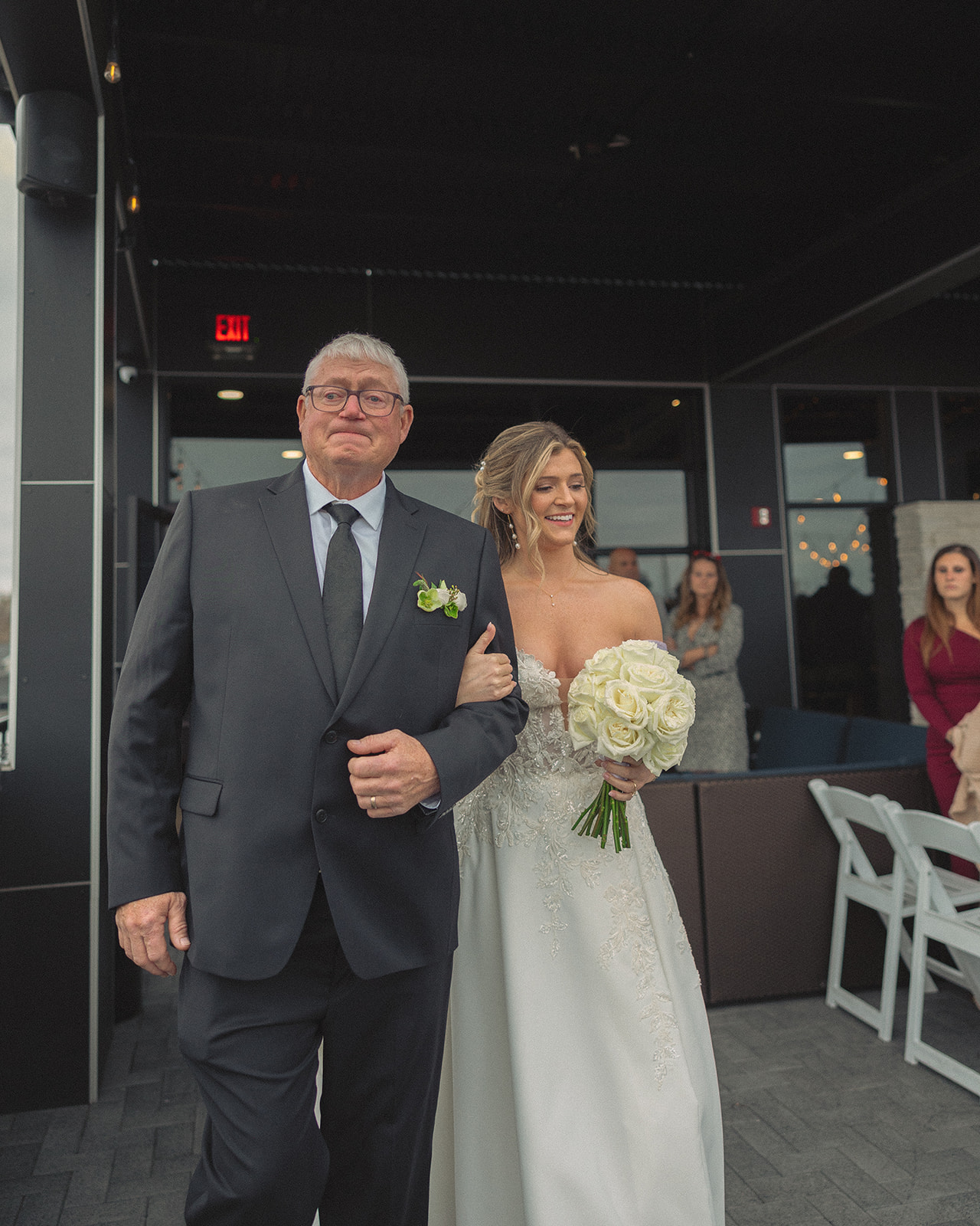 Bride walking down the aisle arm in arm with her father