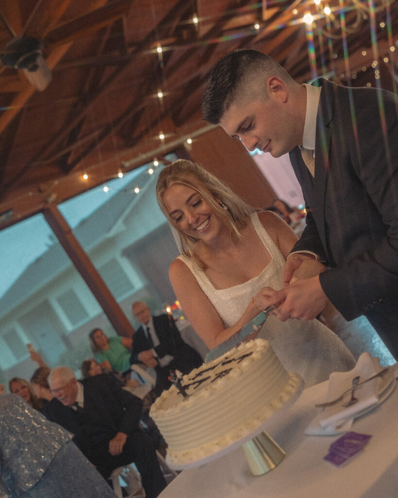 Bride and groom cutting into their wedding cake