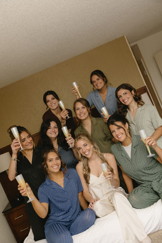 Bride and bridesmaids in their pajamas with champagne glasses