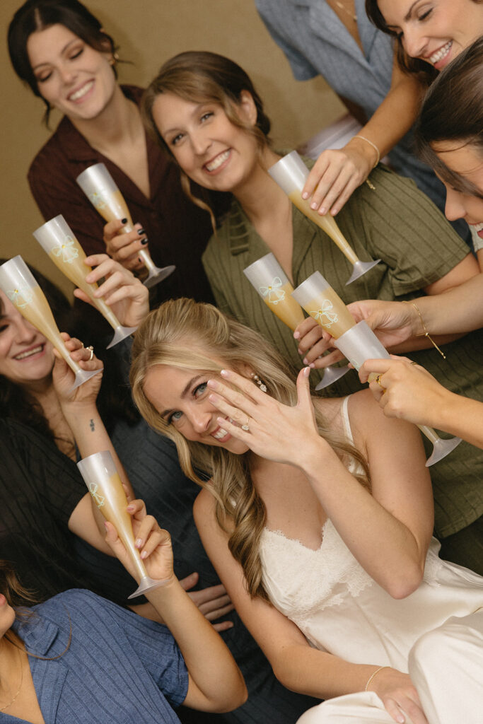 Bride and bridesmaids in their pajamas with champagne glasses