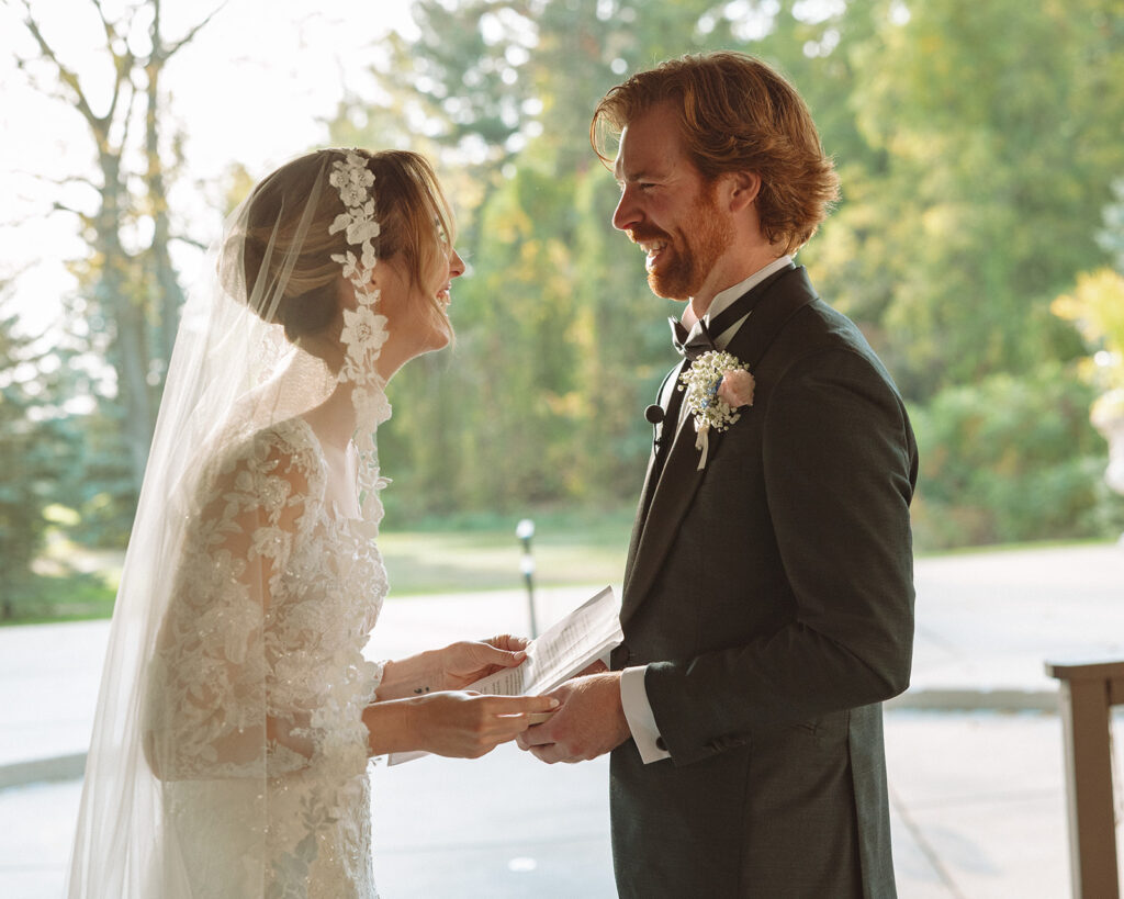 Couple laughing as they exchange vows during their ceremony