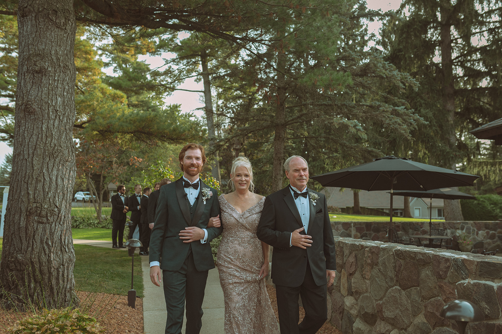 Groom being walked to the altar by his parents