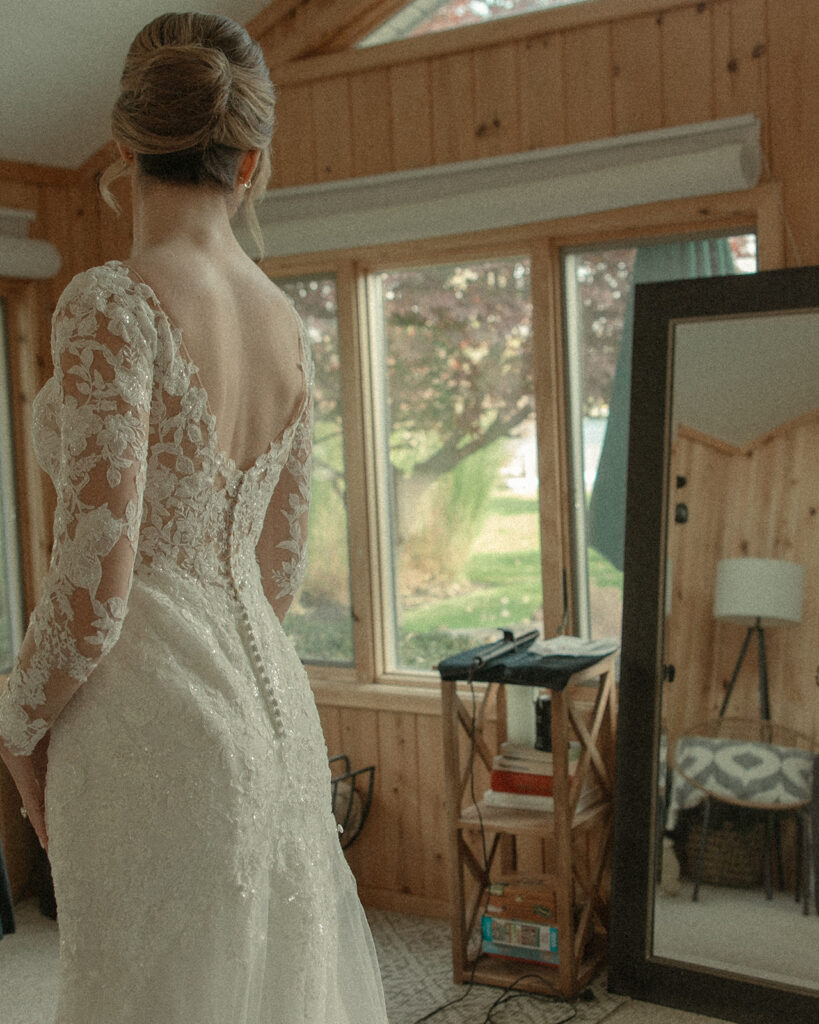 Bride looking at herself in the mirror