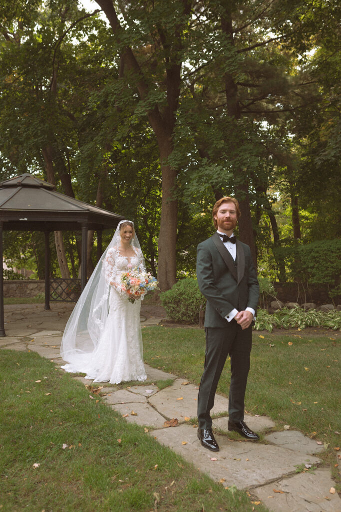 Bride and groom sharing a first look during their Pine Knob Mansion wedding
