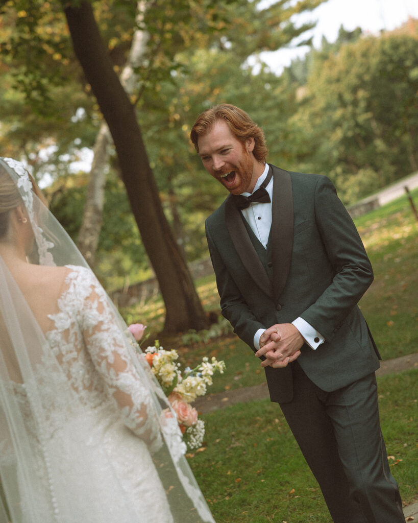 Bride and groom sharing a first look during their Pine Knob Mansion wedding