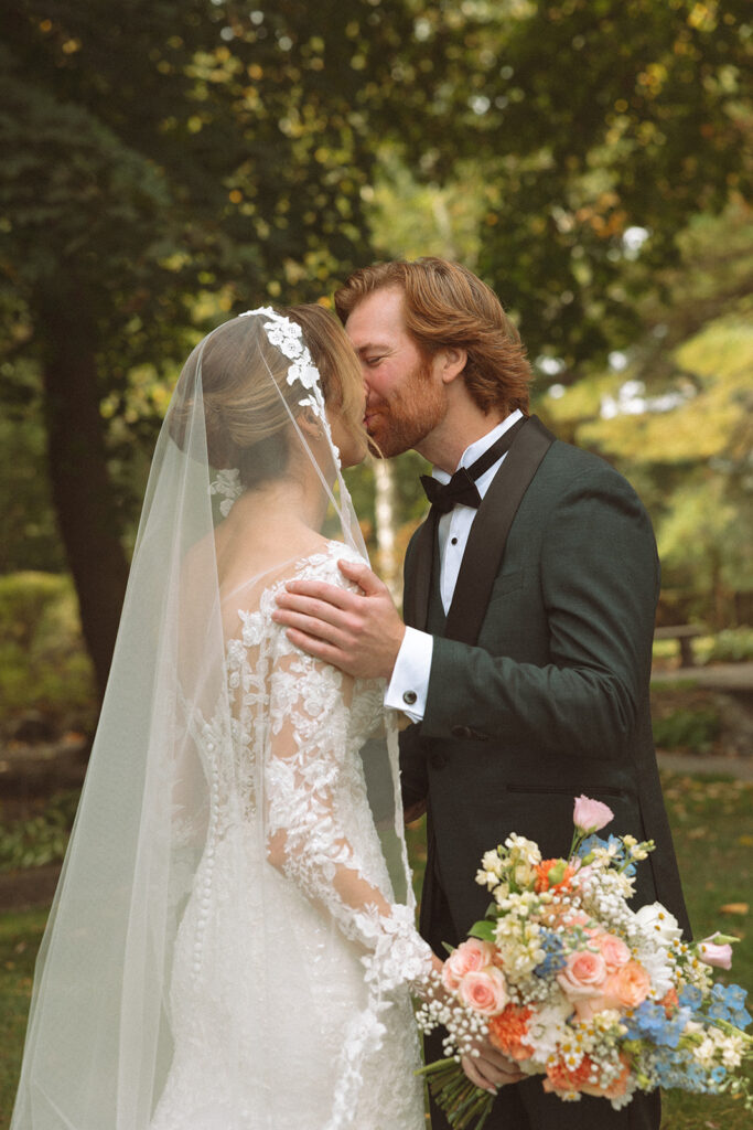 Bride and groom kissing after their first look