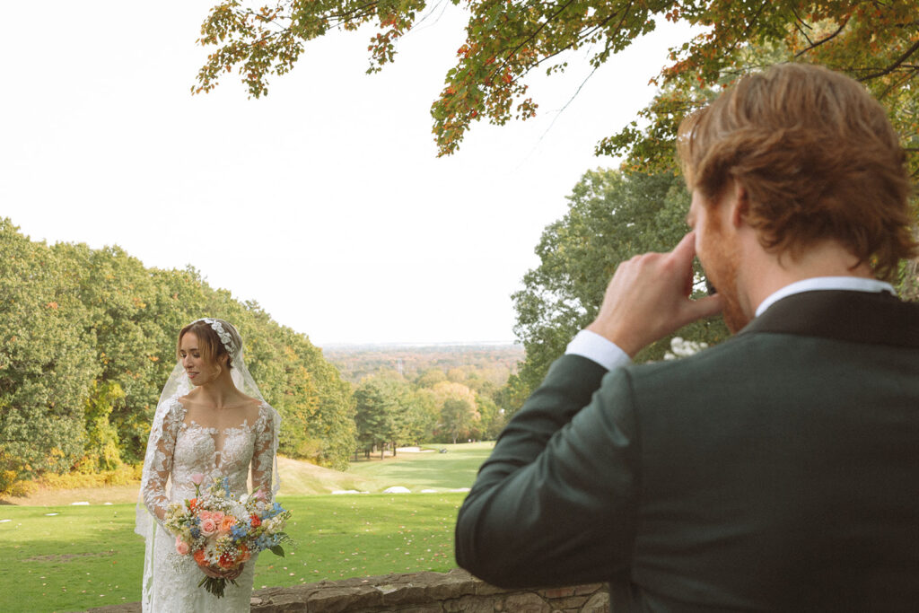 Groom taking photos of his bride