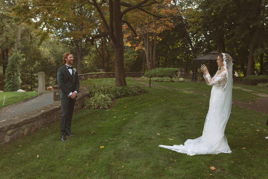 Bride taking photos of the groom