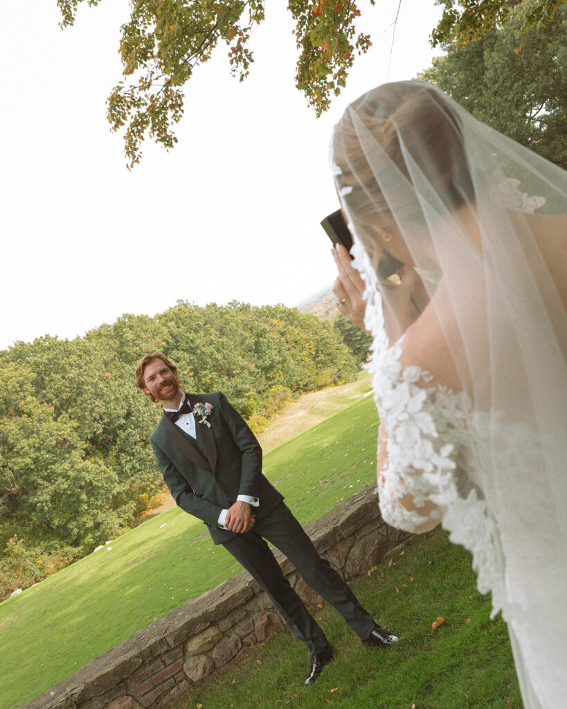 Bride taking photos of the groom