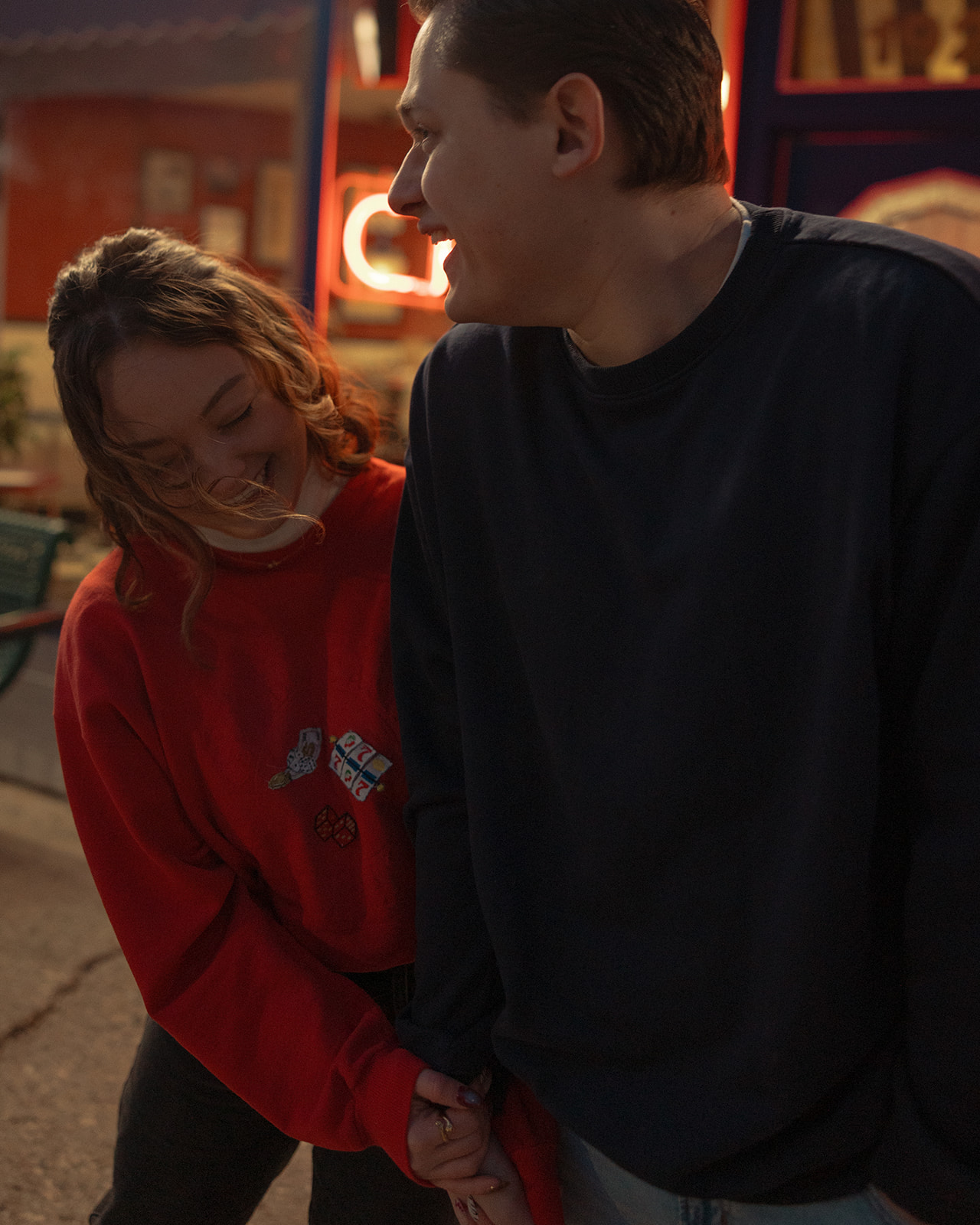 Couple cuddling in close together for their engagement shoot