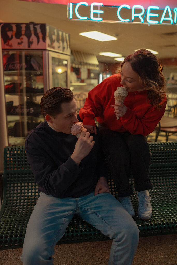 Couple eating ice cream together outside of Mooney's Ice Cream in Michigan