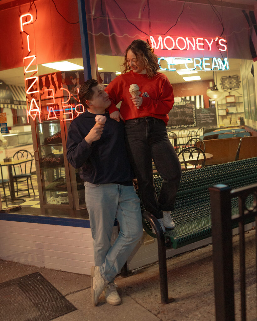 Couple eating ice cream together outside of Mooney's Ice Cream in Michigan