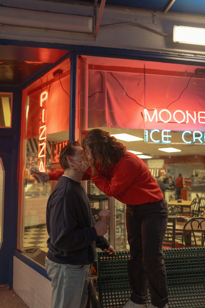 Couple kissing during their Michigan ice cream shop engagement photos
