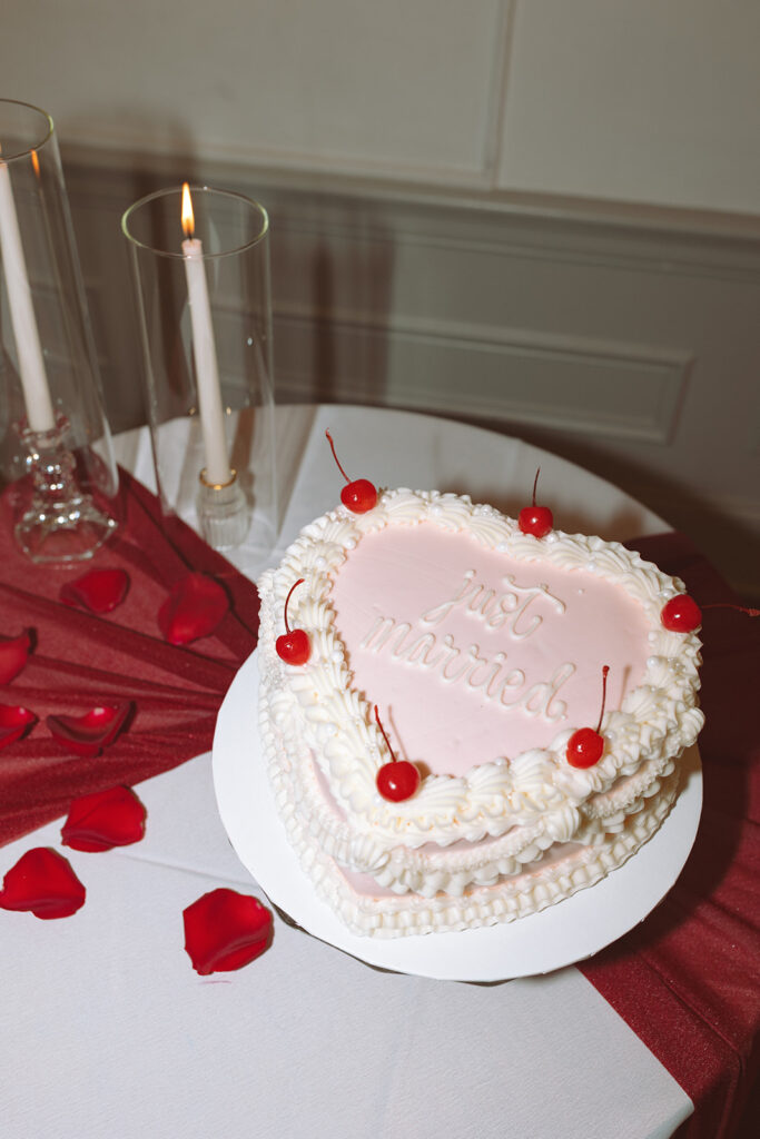 A heart shaped just married elopement cake with cherries