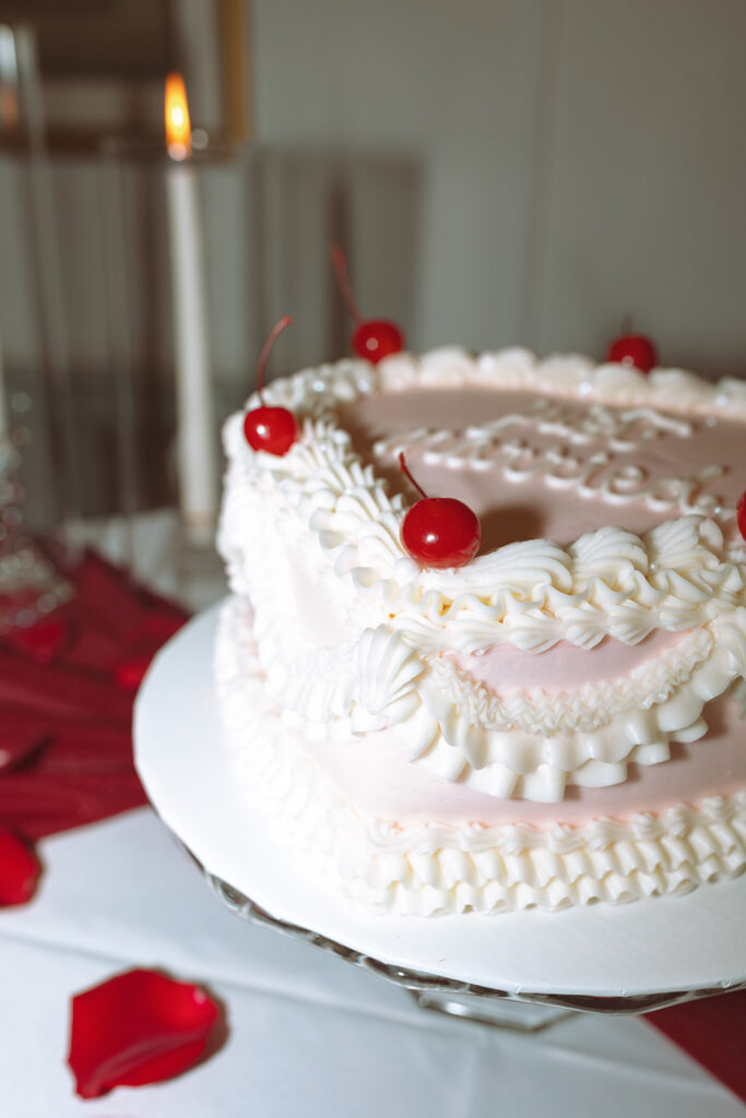 Pink heart-shaped elopement cake that says "just married"