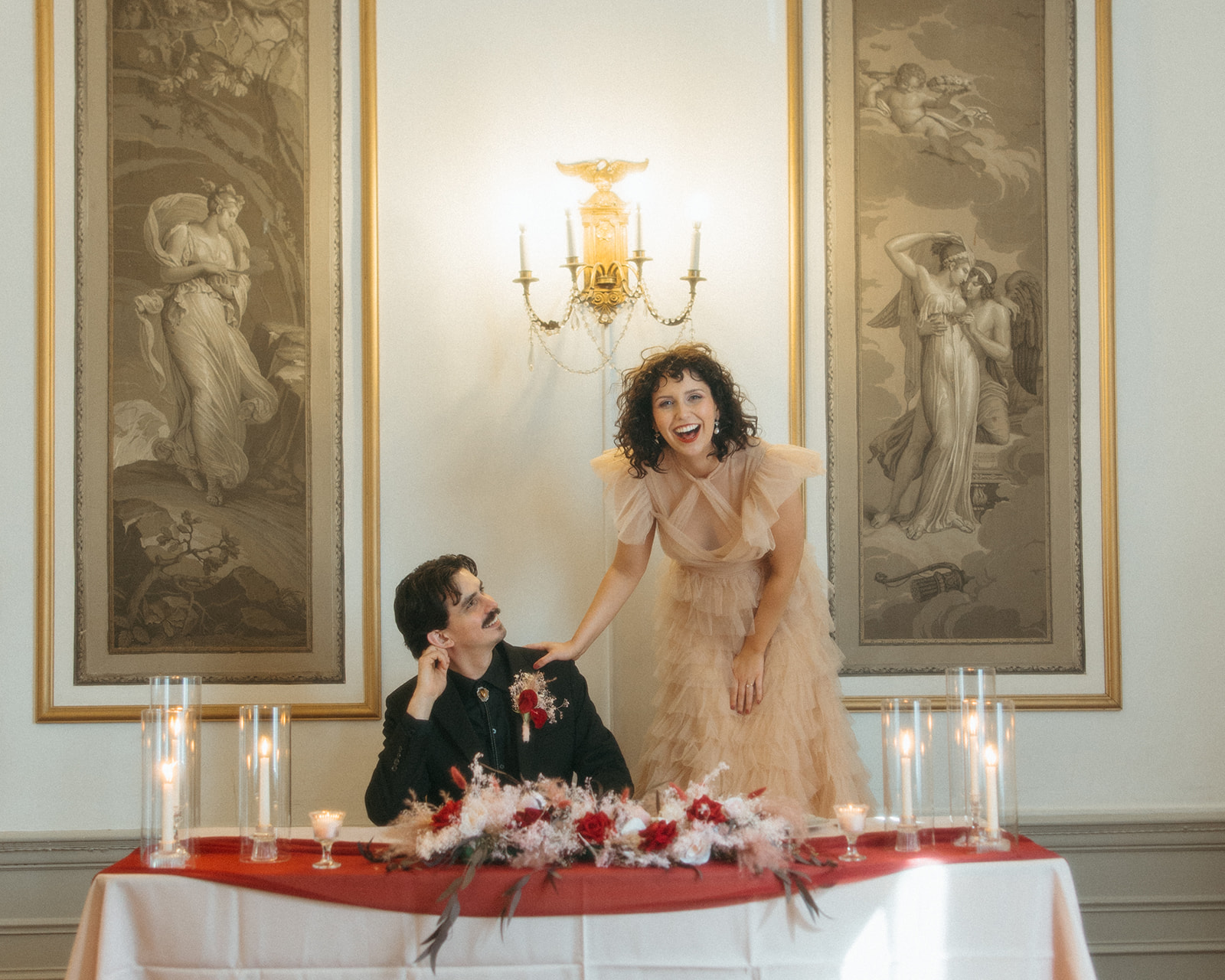 Bride and groom laughing at their sweethearts table