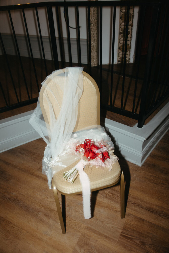 Brides red rose elopement bouquet and veil detail shot
