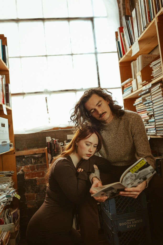 Couple reading a magazine at a Detroit Michigan book store for their engagement photos