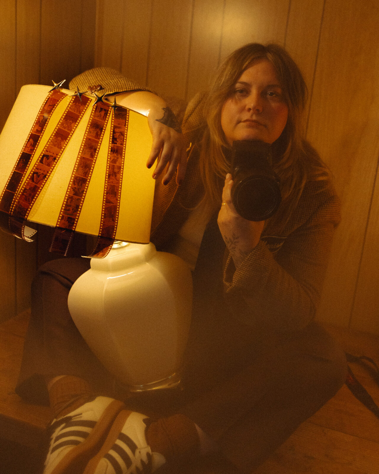 Marissa of Marissa Dillon Photography holding her camera.