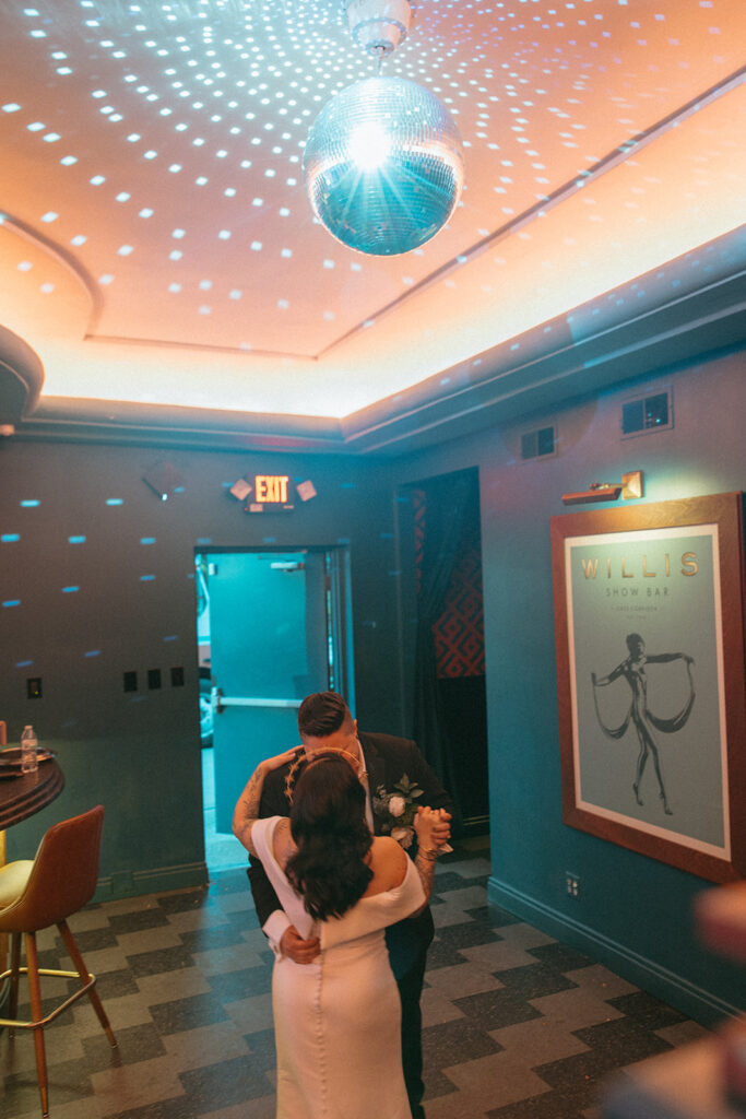 Couple dancing under the disco ball at Willis Show Bar in Detroit, Michigan - Unique Wedding Venues in Michigan