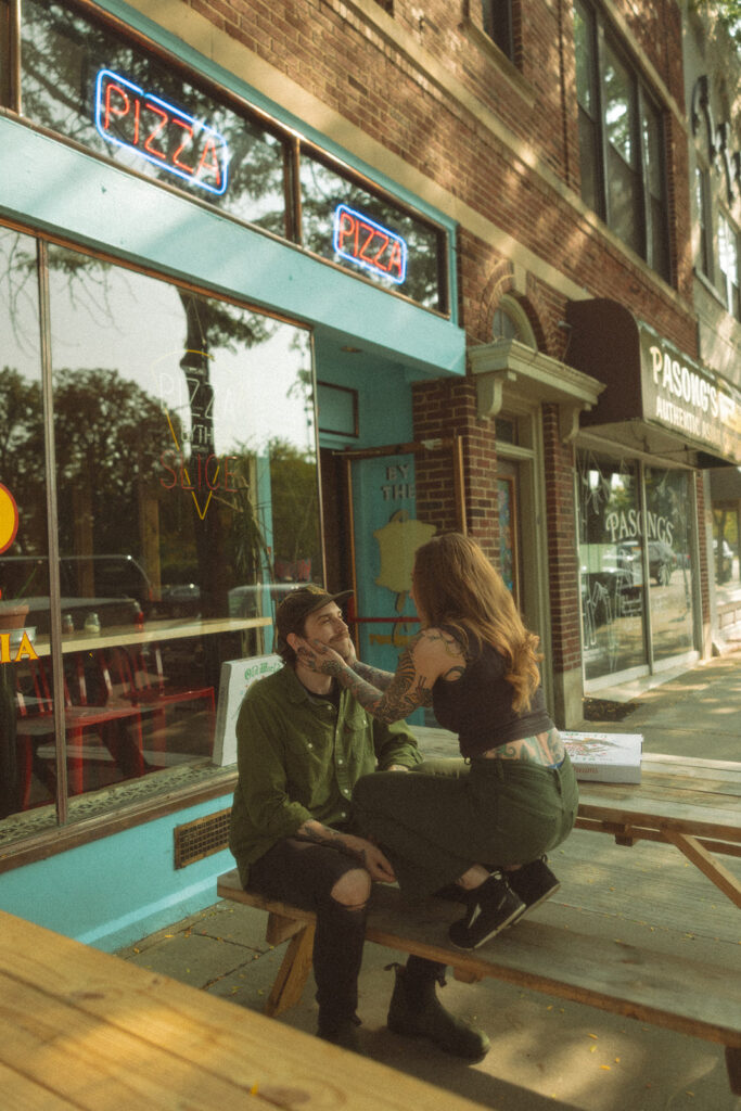 Woman caressing her fiancés face during their casual outdoor engagement session