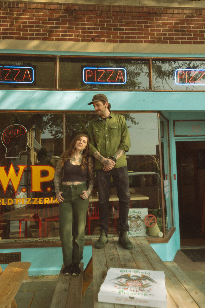 Couple posing outside of a Saginaw, Michigan Pizzeria 