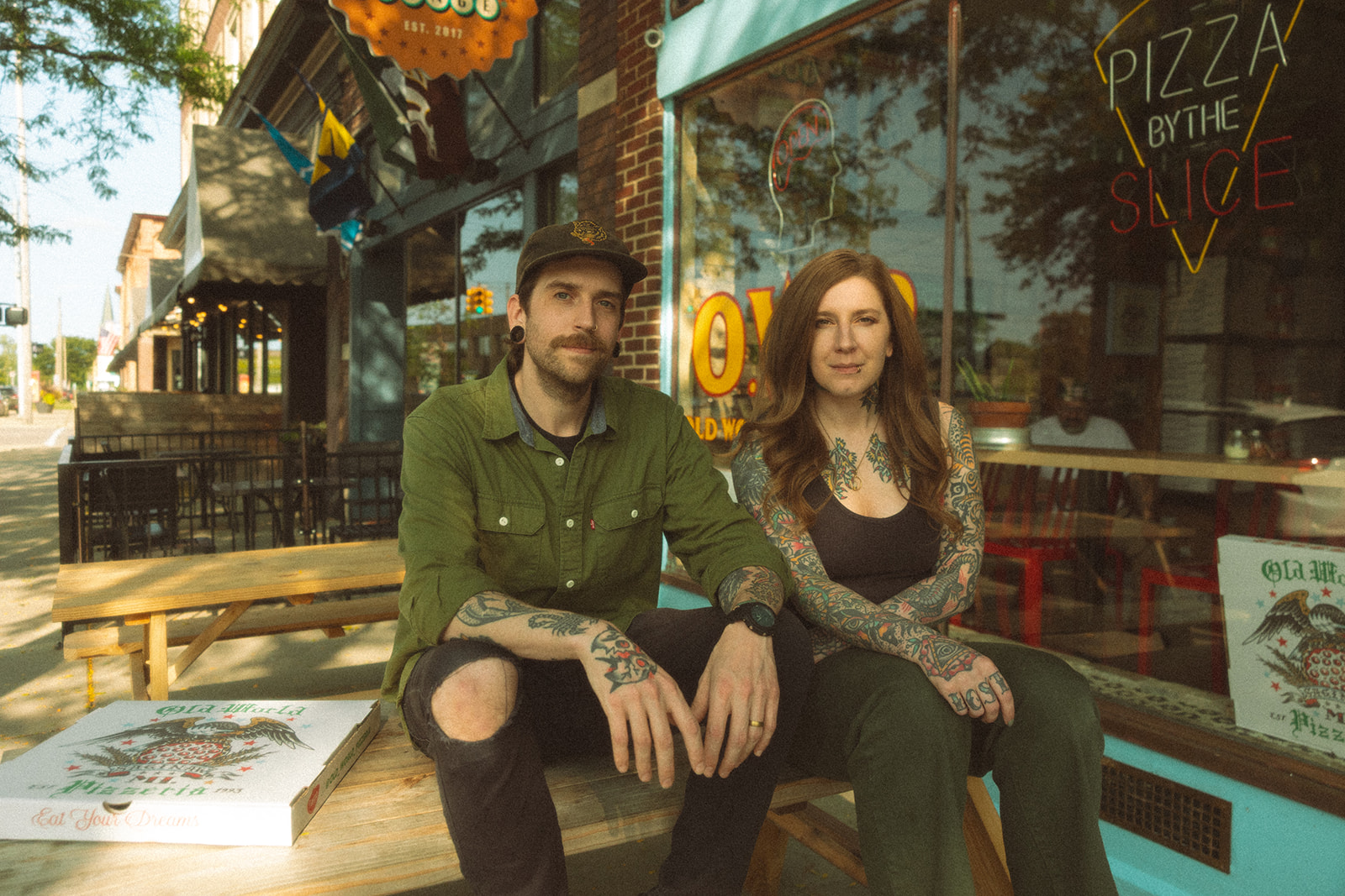 Couple sitting side by side of a picnic table