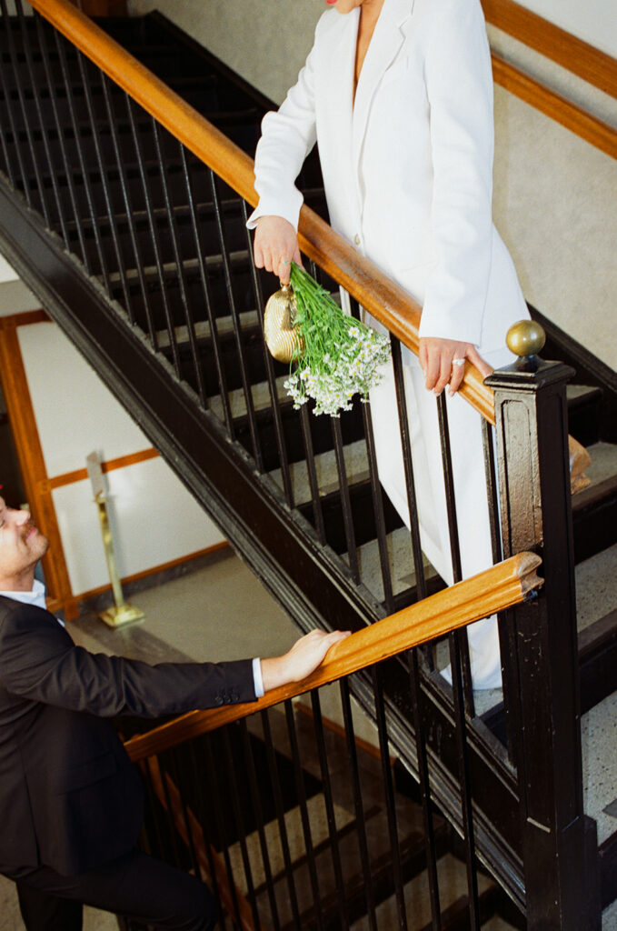 Close up shot of a couple walking up the staircase at Birmingham City Hall.