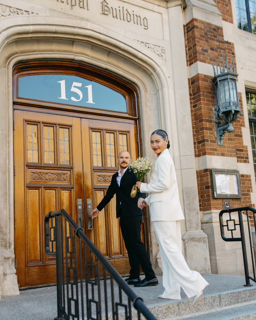 Couple waling up the stairs to Birmingham City Hall.