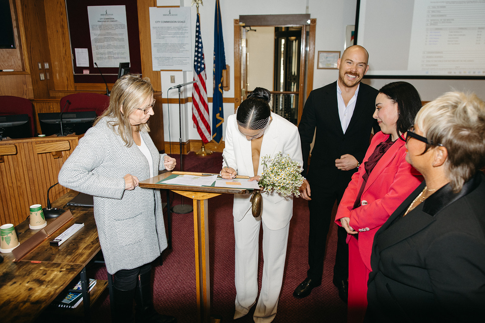 Woman signing her marriage certificate at Birmingham City Hall.