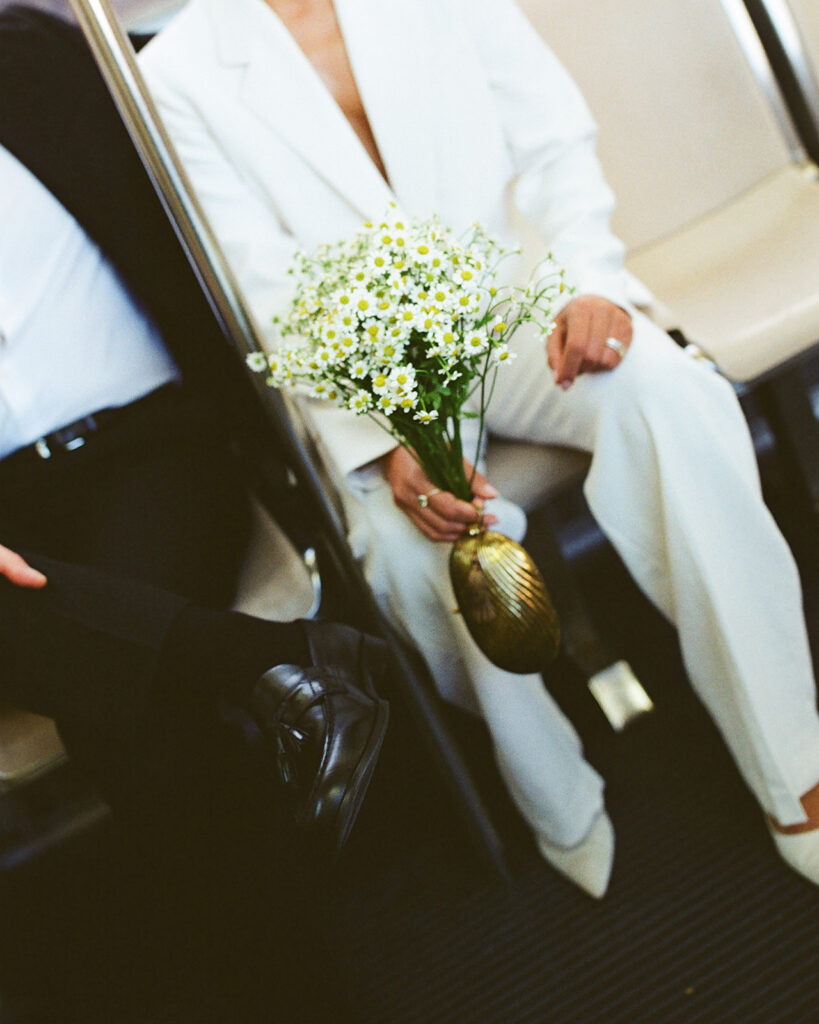 Close up shot of a bride and groom sitting together on the Detroit People Mover.