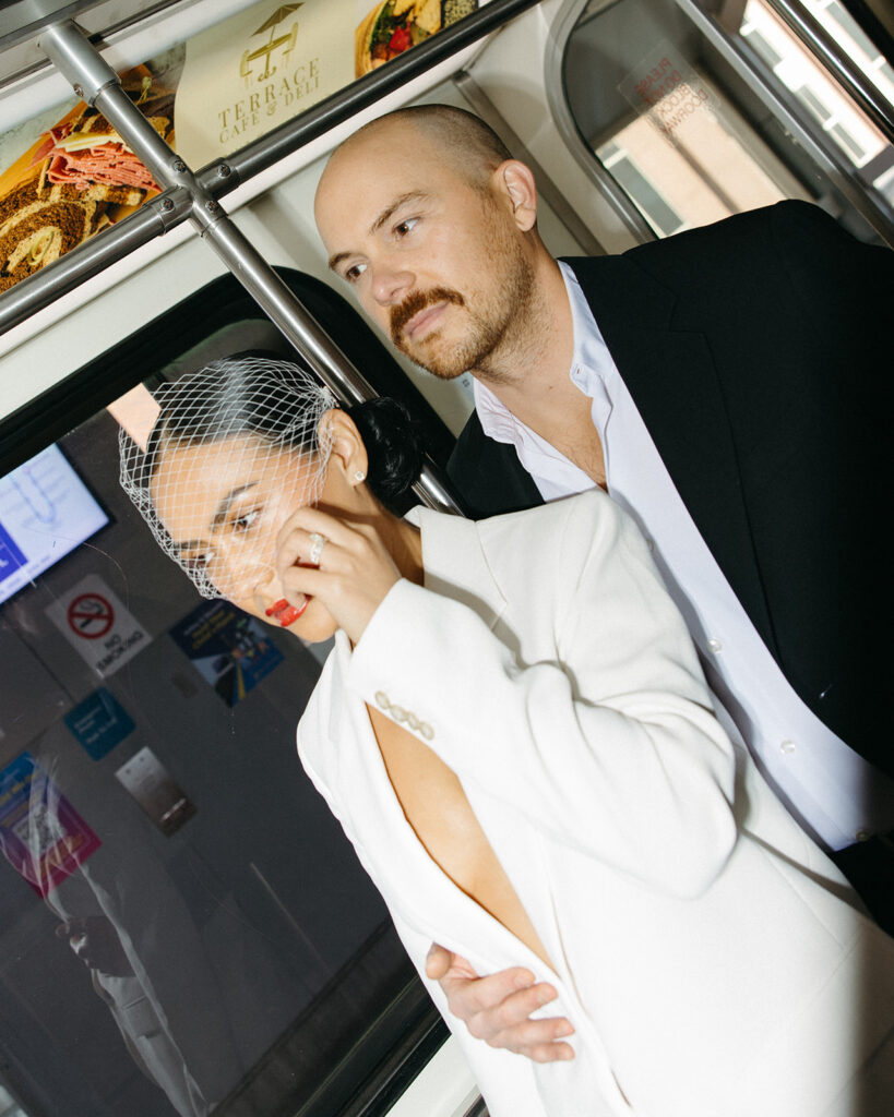 Editorial flash portraits of a couple posing on the People Mover for their Detroit elopement photos.