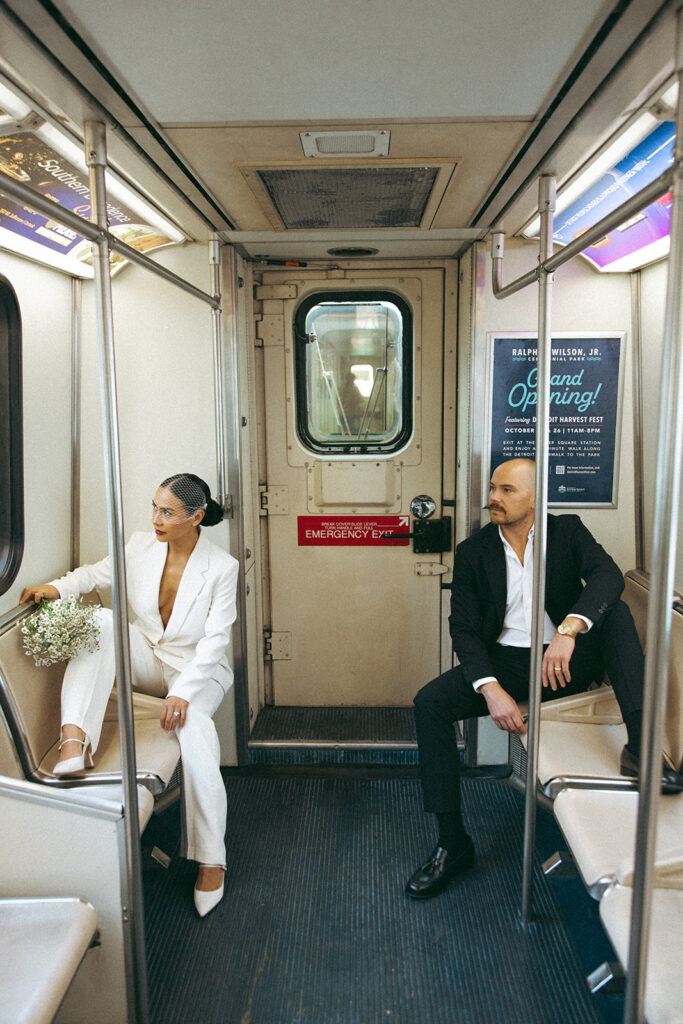 Couple seated across from each other inside the Detroit People Mover.
